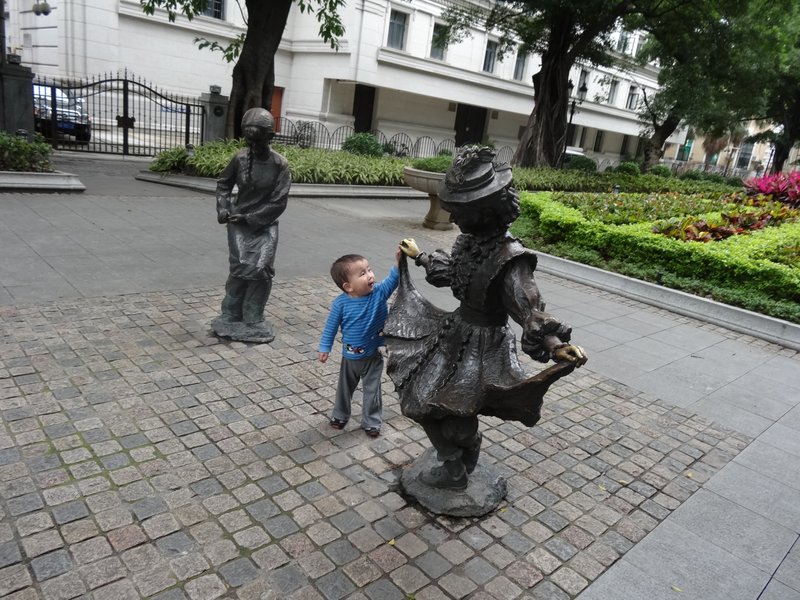 Max trying to dance with a little girl in the Shamian Island mall. She danced like she had two lead feat.